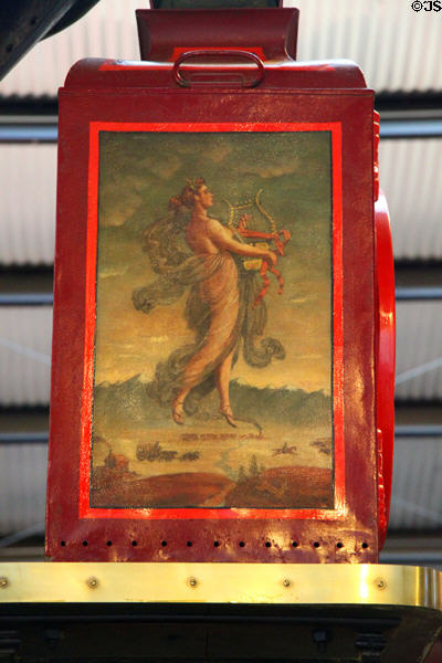 Lantern painted with woman symbolizing progress striding with harp across America on Grizzly Flats narrow gauge steam locomotive #2 (1881) at Orange Empire Railway Museum. Perris, CA.