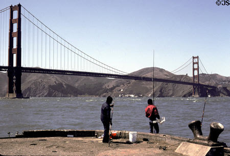 Golden Gate Bridge over fishermen at Marina District. San Francisco, CA.