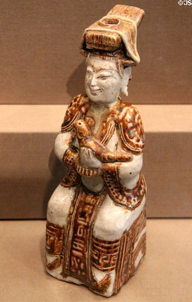 Satchanalai stoneware seated figure with bird (c1500-1700) from Thailand at Asian Art Museum. San Francisco, CA.