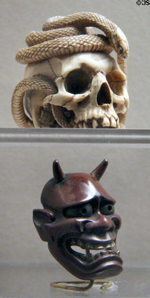 Netsuke of skull with two snakes (1800-1900) & Netsuke of Hannya mask (c1650-1705) from Japan at Asian Art Museum. San Francisco, CA.