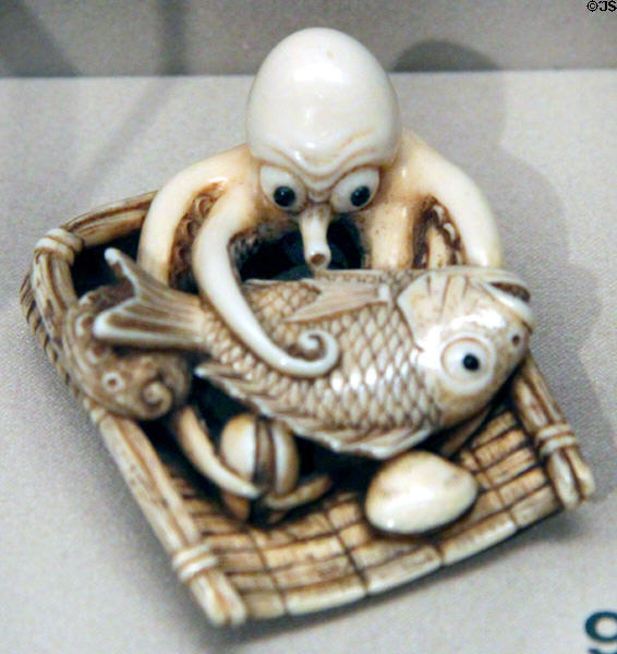 Netsuke of octopus with basket of sea bream, clams, abalone (c1800-1900) from Japan at Asian Art Museum. San Francisco, CA.