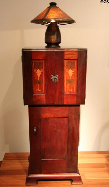 Music cabinet (c1903) by Harvey Ellis for Craftsman Workshops of Eastwood & Syracuse, NY with Old Mission Kopper Kraft lamp (c1922-5) by Frederick Theodore Brosi at de Young Museum. San Francisco, CA.