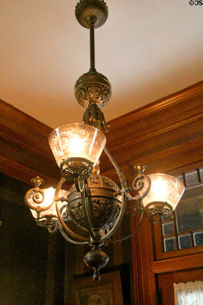 Hallway bronze ceiling gas & electric lamp fixture at Haas-Lilienthal House with tall ceilings to avoid unpleasant coal gas smell. San Francisco, CA.