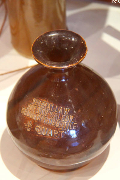 Earthenware quart bottle embossed with "Federal Law Forbids Sale or Reuse of this Bottle" at Angels Camp Museum. Angels Camp, CA.