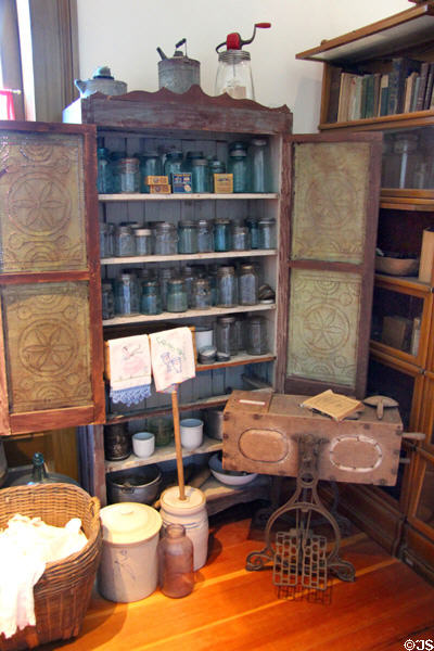 Butter churner & pie safe with display of glass canning jars at Calaveras County Downtown Museum. San Andreas, CA.