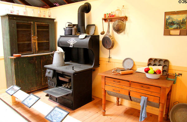 Coal burning cook stove beside baking table with built-in flour bins at Red Barn Museum. San Andreas, CA.