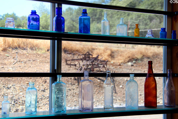 Antique colored bottle display at Red Barn Museum. San Andreas, CA.