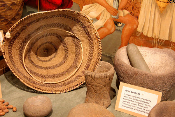 Native American basket & bowl mortars used for preparing acorn flour & pounding seeds at El Dorado County Historical Museum. Placerville, CA.