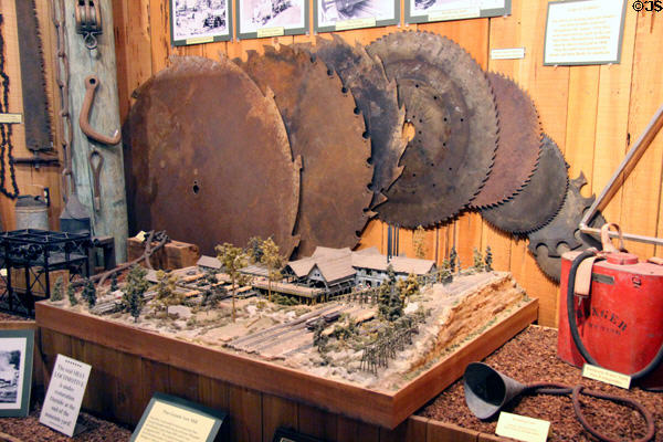 Display of circular saw blades from local lumber industry & model of saw mill at El Dorado County Historical Museum. Placerville, CA.