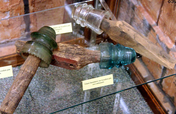 Telegraph glass insulators on wooden pins at El Dorado County Historical Museum. Placerville, CA.