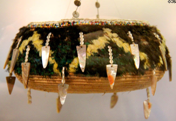 Pomo native basket bowl with abalone & feathers (before 1912) at Oakland Museum of California. Oakland, CA.