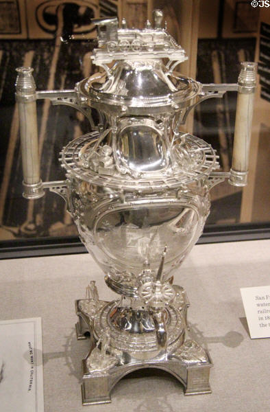 Silver tea urn with railroad scenes used to lobby a Senator to get transcontinental railroad at Oakland Museum of California. Oakland, CA.