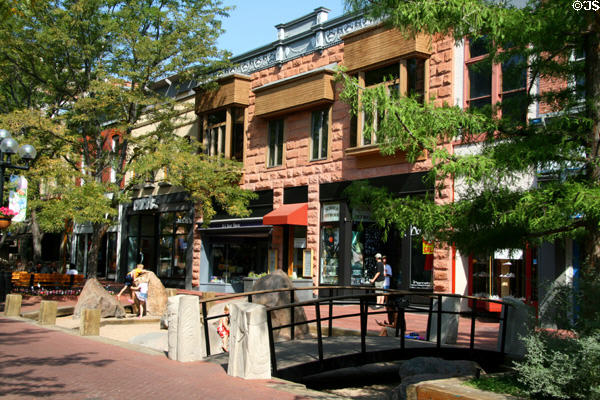 Heritage buildings along Pearl Street Mall with landscaped bridge over boulder arrangement. Boulder, CO.