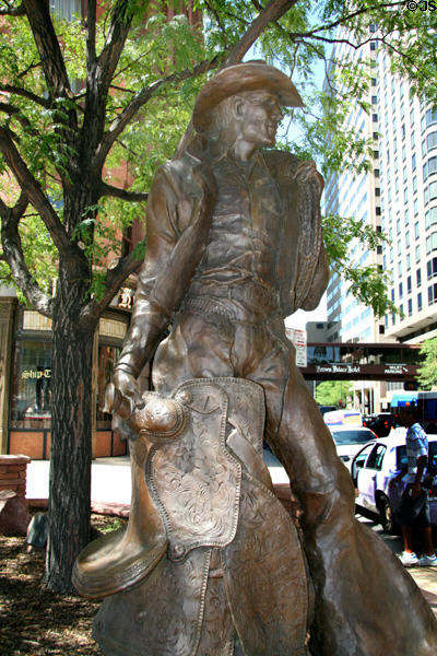 Statue of cowboy with saddle outside Brown Palace Hotel. Denver, CO.