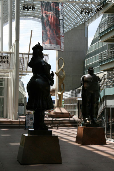Man & Woman sculptures by Fernando Botero under arcade of Denver Performing Arts Complex. Denver, CO.