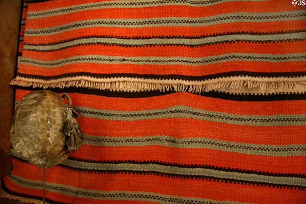 Hispanic wool blanket (late 1800s) & Ute tortoise shell rattle at Colorado History Museum. Denver, CO.