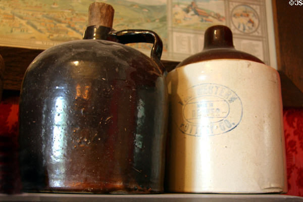 Stoneware liquor crock jugs, one made by Western Pottery Co., Denver at Cripple Creek District Museum. Cripple Creek, CO.