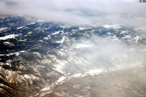 Mist-covered Rocky Mountains from air. CO.