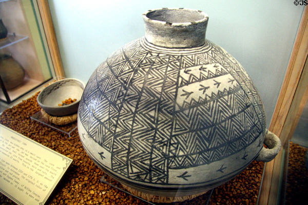 Pueblo pottery corn storage jar with bowl used a protective lid (c1200-1270) found buried with corn inside at Mesa Verde Museum. CO.