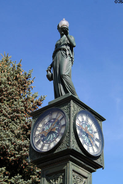 Statue of woman holding lamp atop Wheeler Town Clock. Manitou Springs, CO.