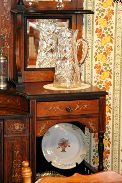 Sideboard with cut glass crystal pitcher plus China plate at Miramont Castle. Manitou Springs, CO.