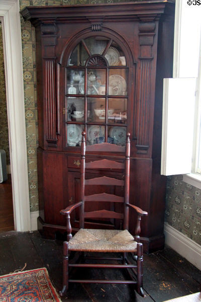 Corner cabinet & ladder-back rocking chair at Butler-McCook House Museum. Hartford, CT.