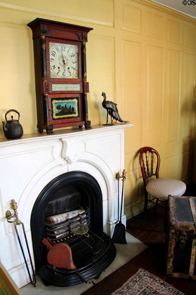 Bedroom fireplace with mantle clock at Butler-McCook House Museum. Hartford, CT.