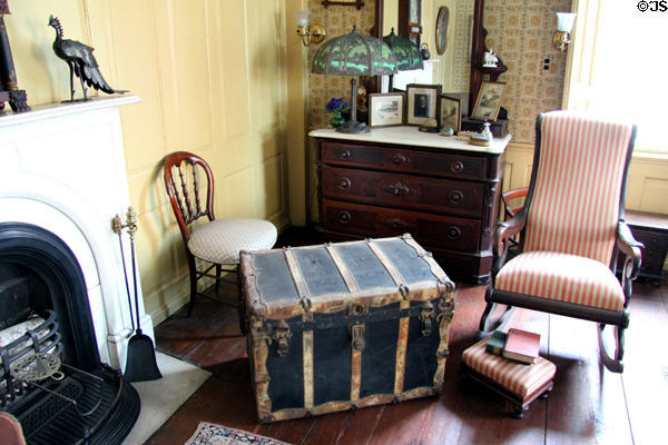 Bedroom with rocking chair & trunk at Butler-McCook House Museum. Hartford, CT.