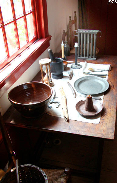 Work table with redware bowl, sugar snips, & candle mold at Noah Webster House. West Hartford, CT.