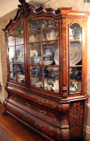 Display cabinet with marquetry shows collection of China at Hurlbut-Dunham House. Wethersfield, CT.