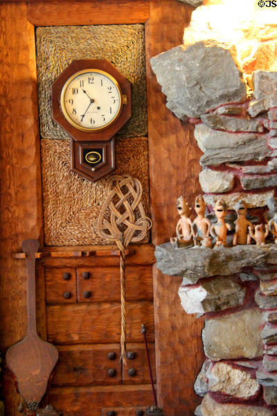 Wall clock & rug beater against grass mat wall at Gillette Castle State Park. East Haddam, CT.