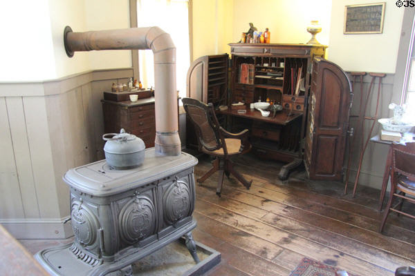 Wooten Patent Desk (1874-97) beside cast iron stove in drug store office at Mystic Seaport. Mystic, CT.