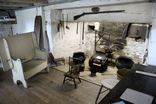 Basement slave quarters fireplace with cooking devices & table which tilts up to become settle bench at Judson House. Stratford, CT.
