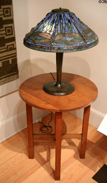 Stained glass dragonfly table lamp (1895-1902) by Louis Comfort Tiffany of New York on round table (c1915) by Gustav Stickley made by Craftsman Workshops of Eastwood, NY at Yale University Art Gallery. New Haven, CT.