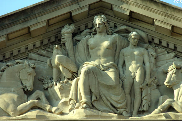 Pediment detail showing woman with torch flanked by horse, eagle, boy & bull on EPA Building. Washington, DC.