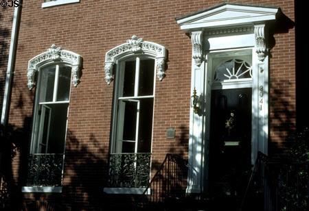 Ornate windows on a red brick Wheatley house (1859) (3041 N St. NW, Georgetown). Washington, DC. Architect: Francis Wheatley, builder.