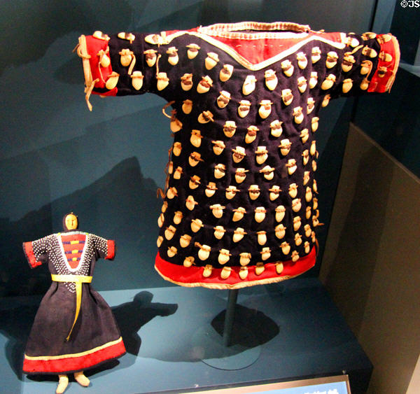 Elk teeth decorated girl's dress (c1915) (Crow nation) & Blackfeet doll (c1850) with beads representing elk's teeth at National Museum of the American Indian. Washington, DC.