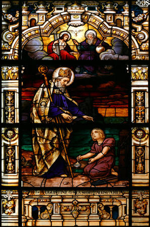 Stained glass window of St Augustine by the sea talking to a child in Cathedral. St Augustine, FL.