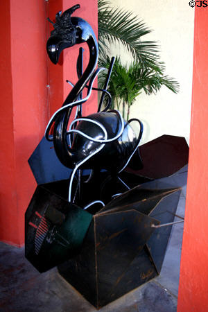Black plastic flamingo rises with noodles from giant take-out food box. Miami Beach, FL.