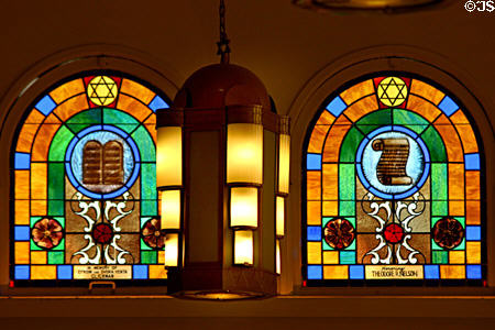 Jewish symbols on stained-glass windows flank Art Deco lamp in Jewish Museum of Florida. Miami Beach, FL.