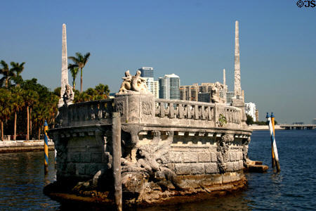 Bow of Stone boat of Vizcaya mansion with condos along shoreline. Miami, FL.