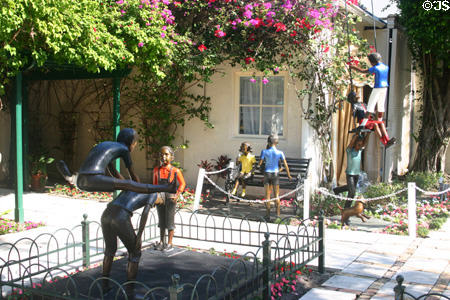 Flowered courtyard with sculptures on Worth Street. Palm Beach, FL.
