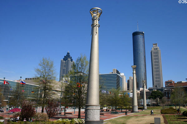 Olympic flame columns of Centennial Olympic Park with skyline of Atlanta. Atlanta, GA.