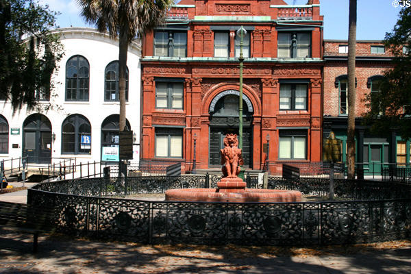 Savannah Cotton Exchange building with winged-lion fountain surrounded by cast iron fence. Savannah, GA.