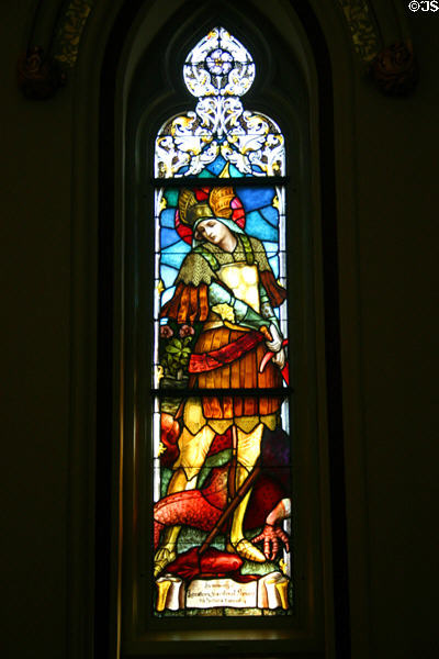 St Michael slaying dragon stained glass window in Cathedral of St John the Baptist. Savannah, GA.