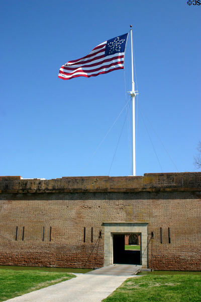 Main gate & star pattern flag at Fort Pulaski Monument. GA.