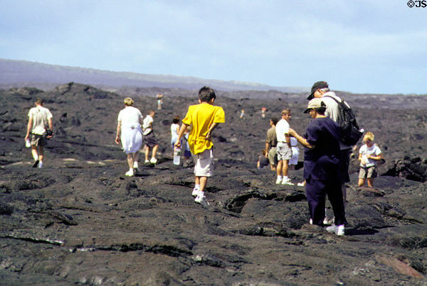 Hikers on lava in Volcanoes National Park. Big Island of Hawaii, HI.