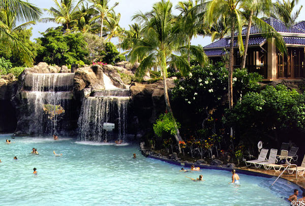 Water falls into swimming pool at Hilton Waikoloa Village, Kona coast. Big Island of Hawaii, HI.