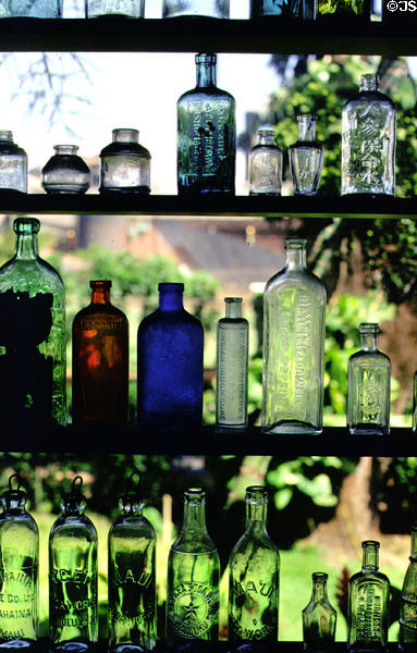 Glass bottles in window of Alexander & Baldwin Sugar Museum. Maui, HI.
