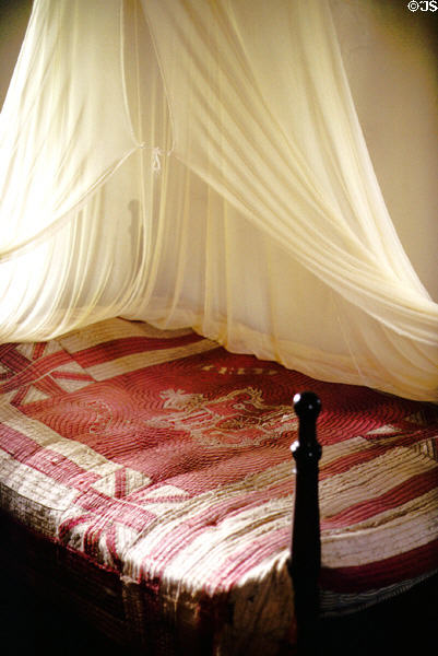 Quilted bed with mosquito netting at Baldwin House Museum in Lahaina. Maui, HI.